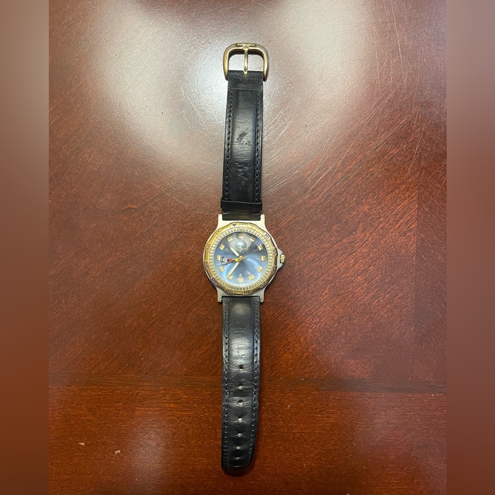 Vintage Disney watch with mickey riding the seconds hand